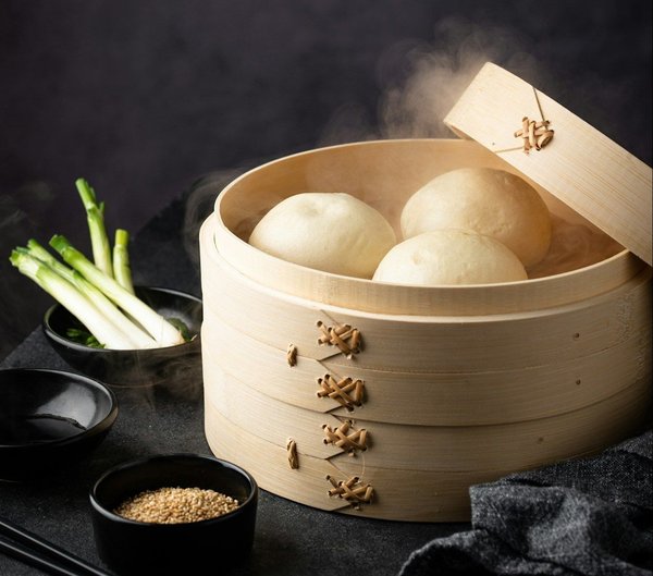 What are the benefits of a multi-tier steamer for cooking complete meals?