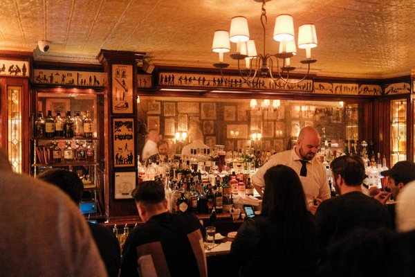 How can a bar optimize its layout to facilitate better social distancing practices?